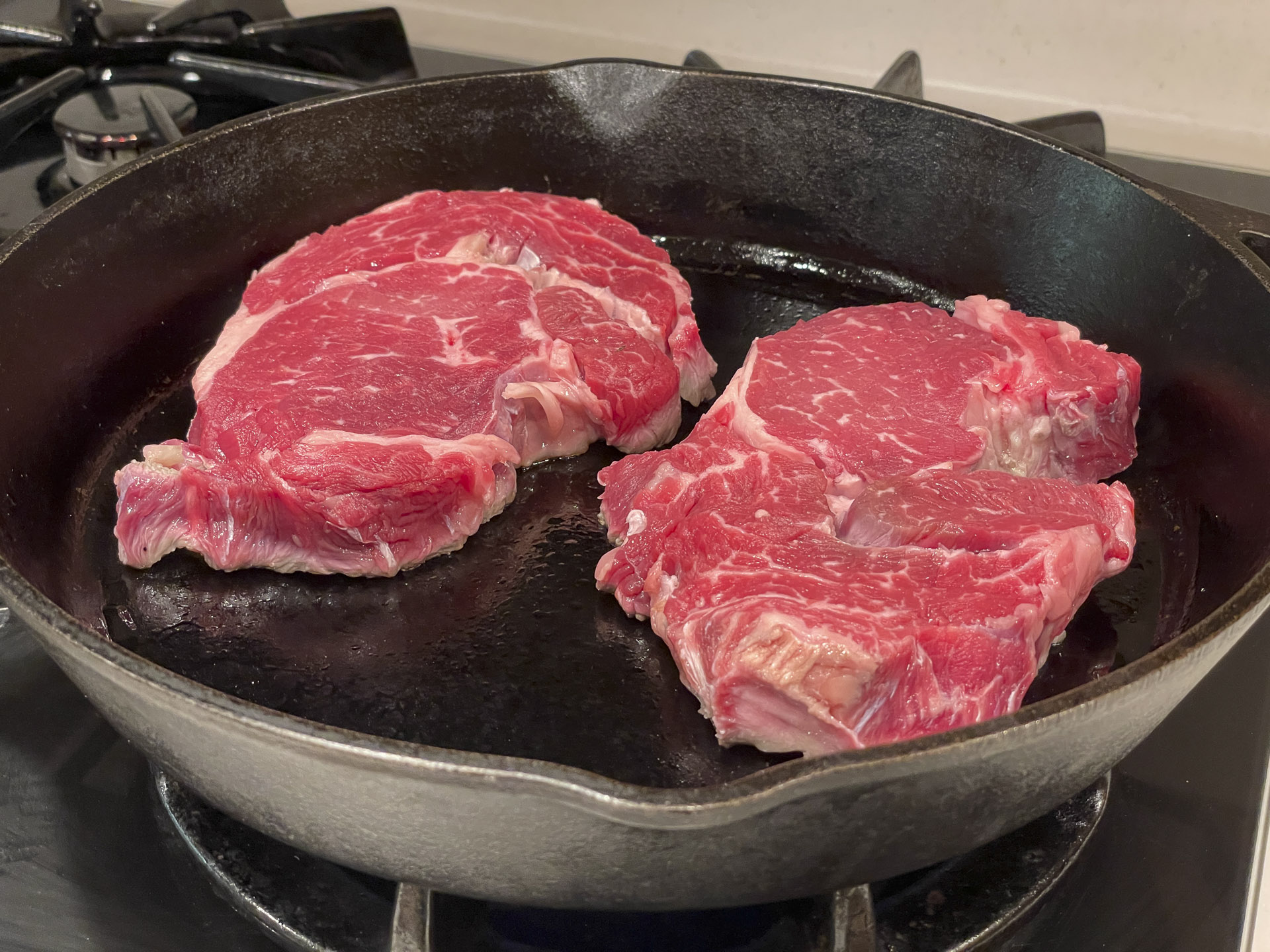 Rib eyes in a frying pan